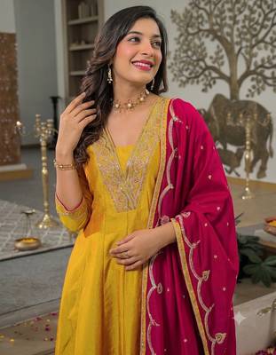 Women’s mustard yellow embroidered long flared kurta pant set with contrast pink border work dupatta 2
