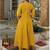 Women’s mustard yellow embroidered long flared kurta pant set with contrast pink border work dupatta