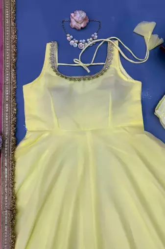 Women yellow anarkali kurta with yellow pant and pink dupatta