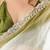 Olive tissue satin embellished saree with unstitched blouse piece.