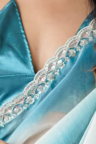 Sky blue tissue satin embellished saree with unstitched blouse piece.