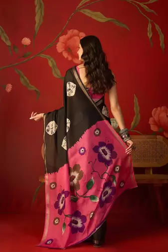 Black silk cotton bandhni printed saree with unstitched blouse piece.