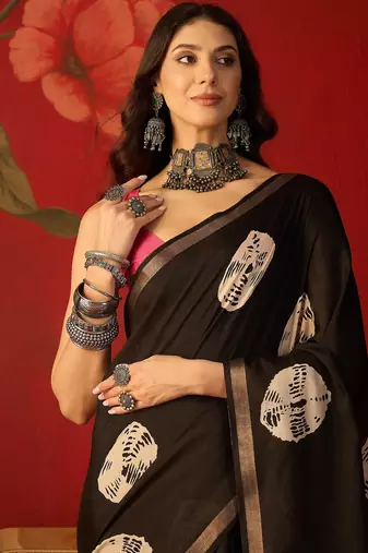 Black silk cotton bandhni printed saree with unstitched blouse piece.