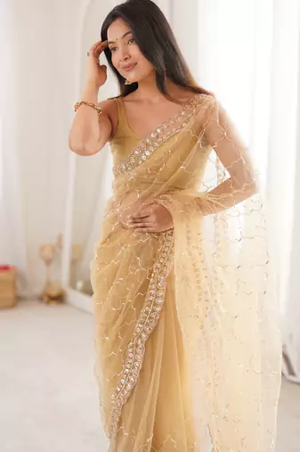 Chiku net embellished saree with unstitched blouse piece.
