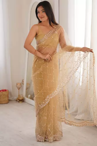 Chiku net embellished saree with unstitched blouse piece.