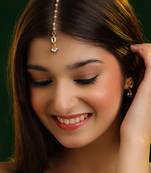 Emerald green stone kundan maang tikka