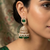 Rose gold plated green stone  studded dome jhumka earrings with pearls