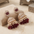 Rose gold plated  ruby stone  studded dome jhumka earrings with pearls