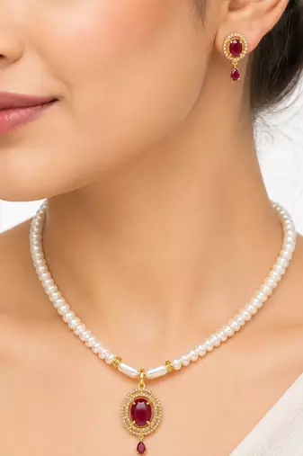 Pearl strand necklace and earring set with ruby pendant gold-tone setting, oval ruby centerpiece, drop earrings included
