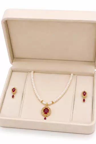 Pearl strand necklace and earring set with ruby pendant gold-tone setting, oval ruby centerpiece, drop earrings included