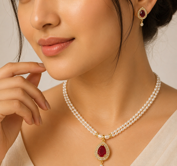 Double strand pearl necklace set with ruby teardrop pendant matching earrings included, gold-tone setting, cz studded. 1