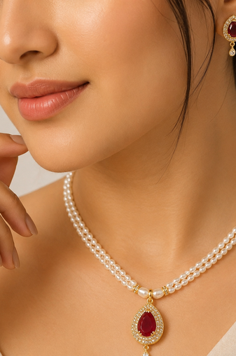 Double strand pearl necklace set with ruby teardrop pendant matching earrings included, gold-tone setting, cz studded.