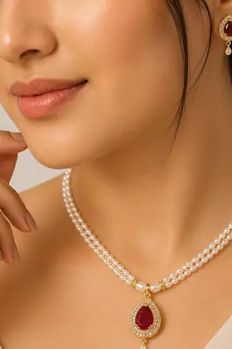 Double strand pearl necklace set with ruby teardrop pendant matching earrings included, gold-tone setting, cz studded.
