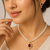Double strand pearl necklace set with ruby teardrop pendant matching earrings included, gold-tone setting, cz studded.