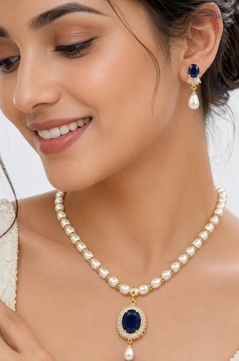 Pearl necklace & earring set with blue sapphire pendant gold-tone accents, cz baguette surround, drop earrings included