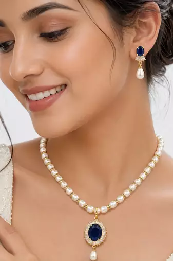 Pearl necklace & earring set with blue sapphire pendant gold-tone accents, cz baguette surround, drop earrings included