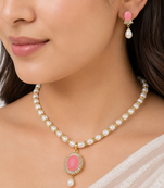 Pearl necklace and earring set with pink stone pendant cz baguette accents, gold-tone finish, drop earrings included.