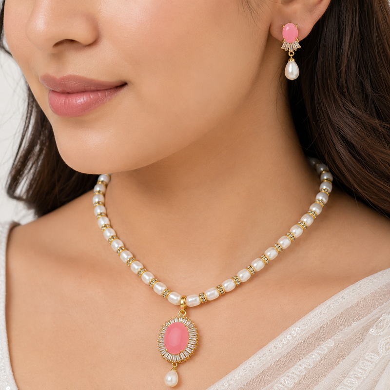 Pearl necklace and earring set with pink stone pendant cz baguette accents, gold-tone finish, drop earrings included.
