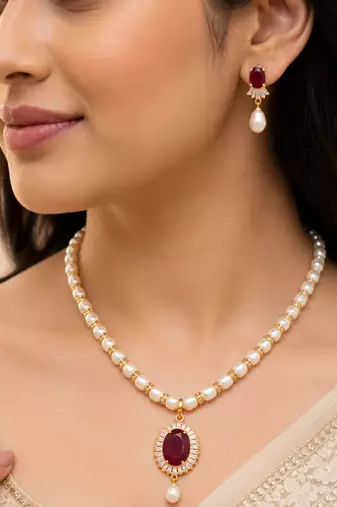 Pearl necklace and earring set with ruby pendant cz baguette accents, gold-tone spacers, drop earrings included.
