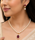Pearl necklace and earring set with ruby pendant cz baguette accents, gold-tone spacers, drop earrings included.