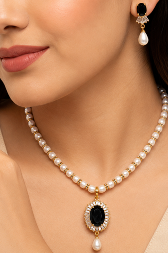 Pearl beaded necklace & earring set with black oval pendant gold-tone accents, cz baguette halo, drop earrings included.