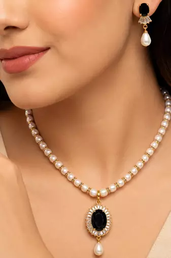 Pearl beaded necklace & earring set with black oval pendant gold-tone accents, cz baguette halo, drop earrings included.