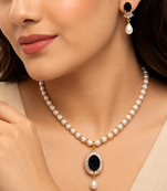 Pearl beaded necklace & earring set with black oval pendant gold-tone accents, cz baguette halo, drop earrings included.