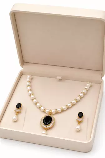 Pearl beaded necklace & earring set with black oval pendant gold-tone accents, cz baguette halo, drop earrings included.