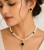Pearl beaded necklace and earrings set with black stone pendant gold-tone finish, cz baguette accents, drop earrings.