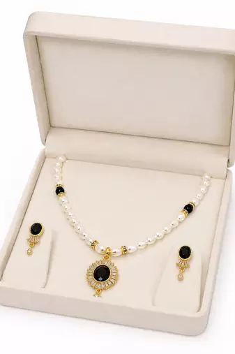Pearl beaded necklace and earrings set with black stone pendant gold-tone finish, cz baguette accents, drop earrings.
