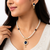 Pearl necklace and earring set with blue sapphire pendant gold-tone finish, cz baguette halo, blue stone accents.