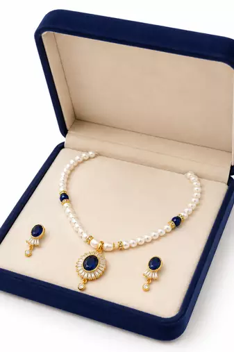 Pearl necklace and earring set with blue sapphire pendant gold-tone finish, cz baguette halo, blue stone accents.