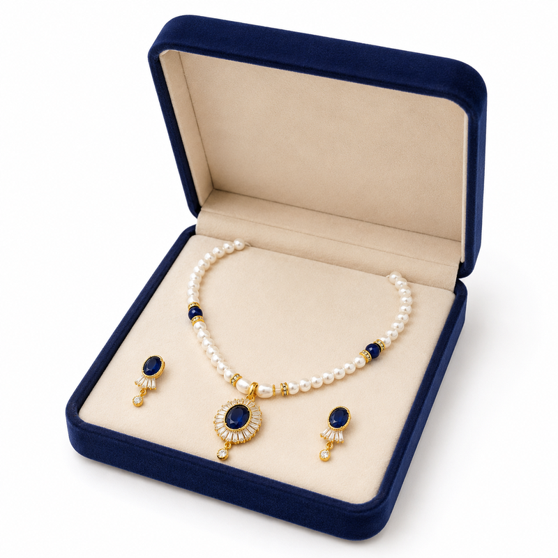 Pearl necklace and earring set with blue sapphire pendant gold-tone finish, cz baguette halo, blue stone accents.