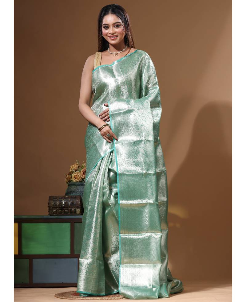 green silk blend saree with blouse piece