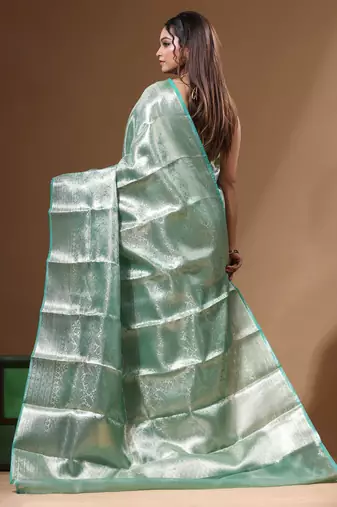 green silk blend saree with blouse piece