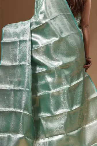 green silk blend saree with blouse piece