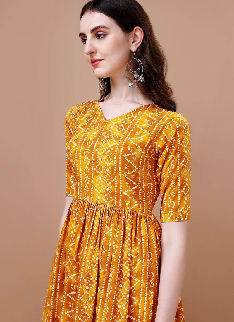 YELLOW BANDHANI FOLI PRINT DESIGN WORK WITH RAYON FABRIC KURTI 