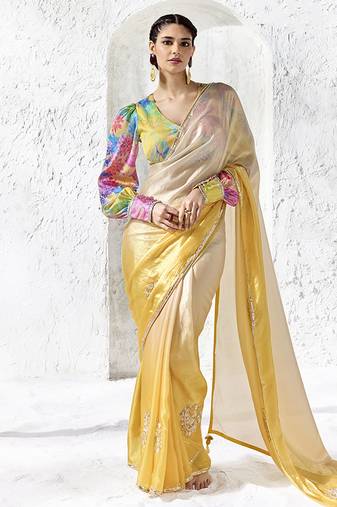cream & yellow faux organza saree with floral printed blouse & zari border
