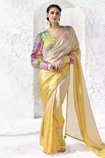 cream & yellow faux organza saree with floral printed blouse & zari border