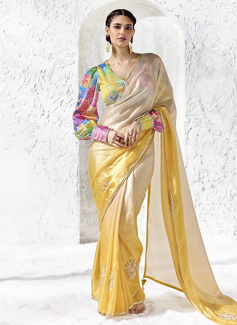cream & yellow faux organza saree with floral printed blouse & zari border