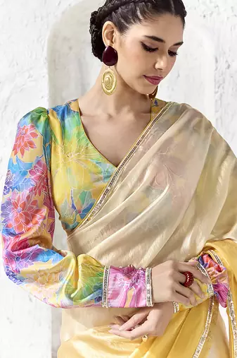 cream & yellow faux organza saree with floral printed blouse & zari border