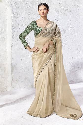 cream faux organza saree with zari border & green printed blouse