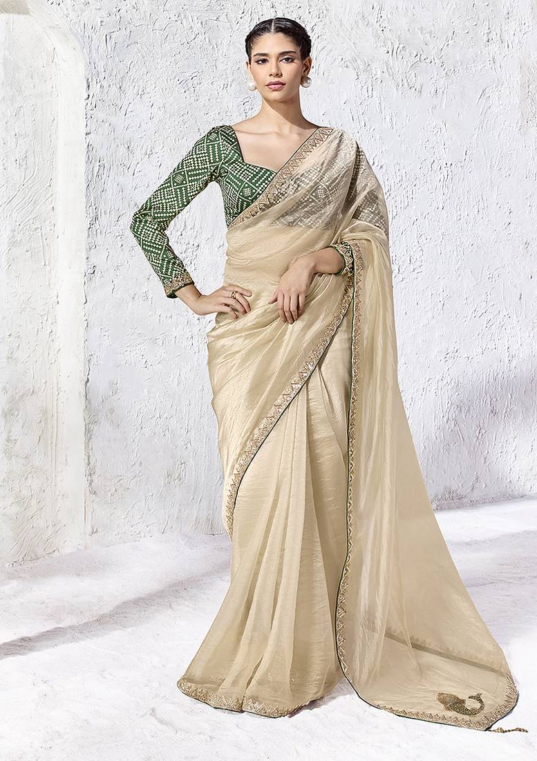 cream faux organza saree with zari border & green printed blouse
