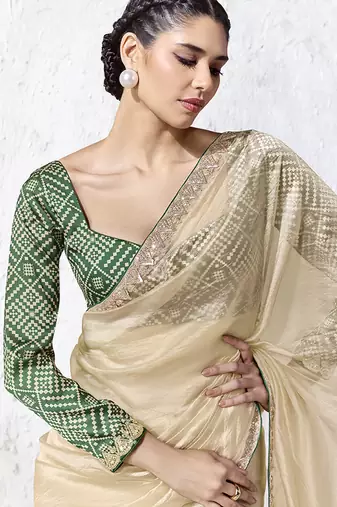 cream faux organza saree with zari border & green printed blouse