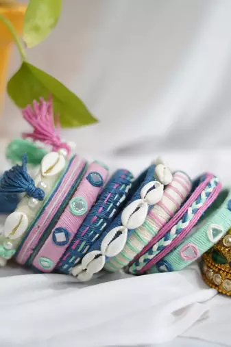  handcrafted pastel multicolour thread bangle set with cowrie shells & tassels