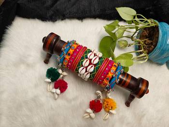  handcrafted multicolour navratri thread bangle set with cowrie shells & pom-poms 1