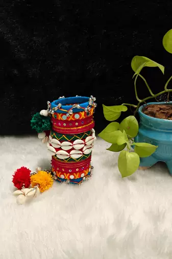  handcrafted multicolour navratri thread bangle set with cowrie shells & pom-poms