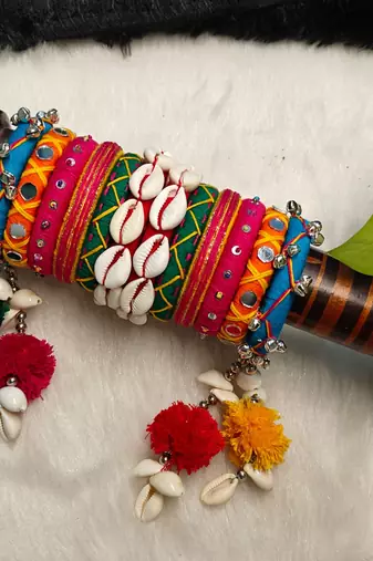  handcrafted multicolour navratri thread bangle set with cowrie shells & pom-poms