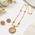 Gold-toned pearl & crystal spiral pendant necklace filigree spiral design, pearl beaded chain, crystal embellished.