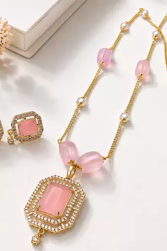 Pink stone pendant necklace and earrings jewellery set gold-tone chain, crystal embellished, pearl accents, rectangular.